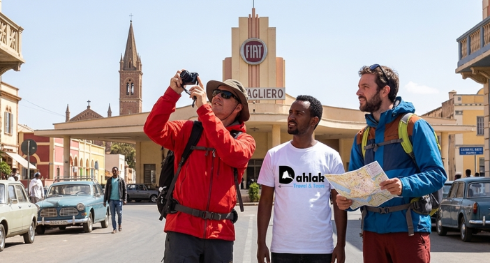 Dahlak Tours guide and traveller photographing the Fiat Tagliero building in Asmara